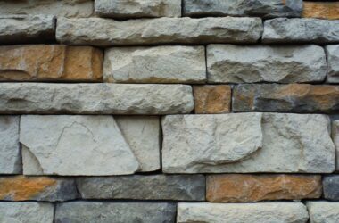 Close-up of a textured stone wall with a variety of natural colors.