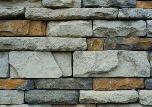 Close-up of a textured stone wall with a variety of natural colors.